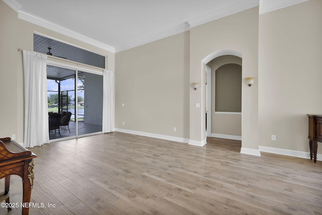 1506 Waterbridge Ct, Fleming Island, FL 32003 - unfurnished living room with ornamental molding, wood finished floors, and arched walkways