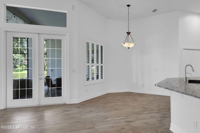 1506 Waterbridge Ct, Fleming Island, FL 32003 - unfurnished dining area featuring wood finished floors and french doors
