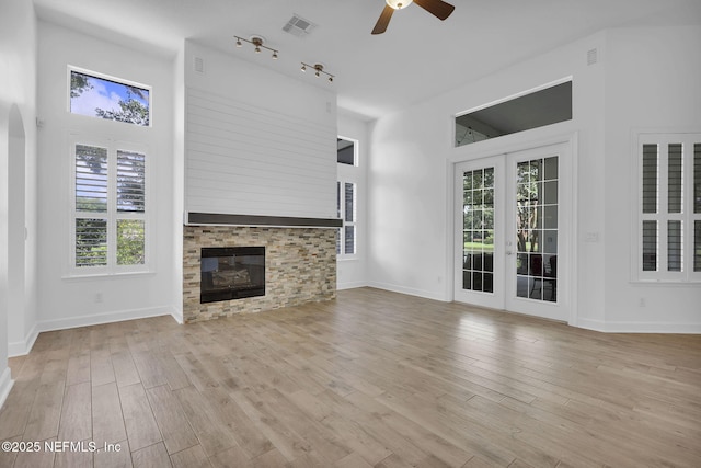 1506 Waterbridge Ct, Fleming Island, FL 32003 - unfurnished living room featuring ceiling fan, a towering ceiling, plenty of natural light, and wood finished floors