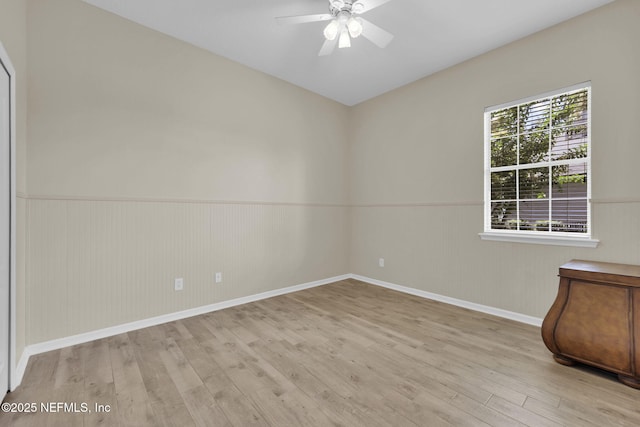 1506 Waterbridge Ct, Fleming Island, FL 32003 - spare room with wood finished floors, ceiling fan, and a wainscoted wall