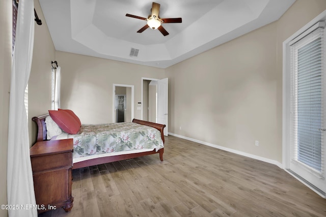 1506 Waterbridge Ct, Fleming Island, FL 32003 - bedroom featuring a raised ceiling, wood finished floors, and ceiling fan