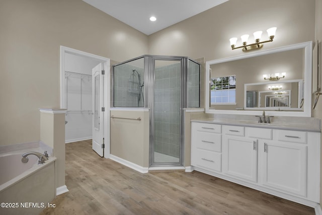 1506 Waterbridge Ct, Fleming Island, FL 32003 - full bathroom featuring a stall shower, a garden tub, vanity, a walk in closet, and a chandelier