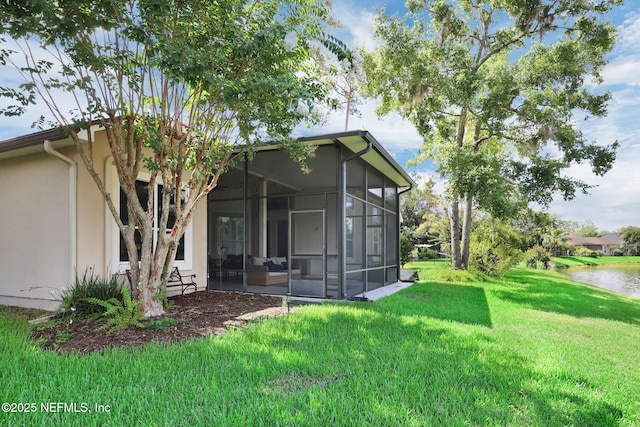1506 Waterbridge Ct, Fleming Island, FL 32003 - rear view of property with a sunroom, a yard, stucco siding, and a water view