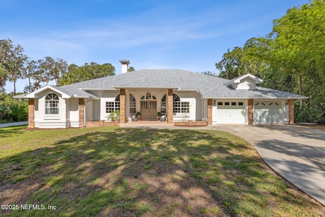 1465 Lambert Ave, Flagler Beach, FL 32136 - ranch-style home with driveway, an attached garage, a front lawn, and brick siding