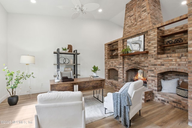 1465 Lambert Ave, Flagler Beach, FL 32136 - living room with a fireplace, ceiling fan, wood finished floors, high vaulted ceiling, and recessed lighting