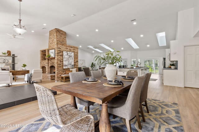 1465 Lambert Ave, Flagler Beach, FL 32136 - dining space featuring light wood-style floors, a skylight, high vaulted ceiling, and recessed lighting