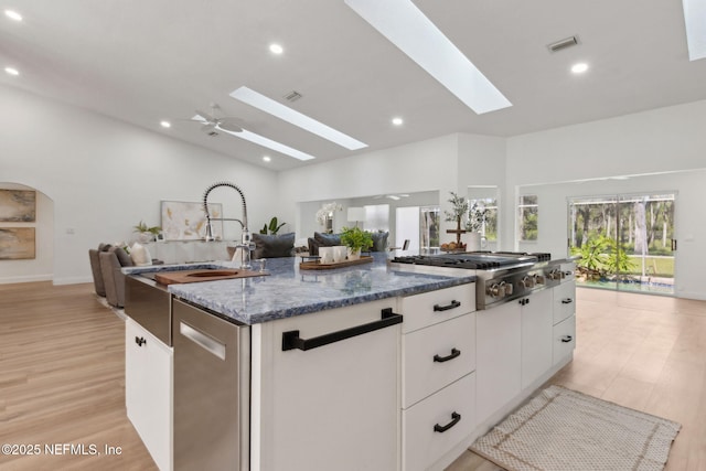 1465 Lambert Ave, Flagler Beach, FL 32136 - kitchen featuring a skylight, open floor plan, stainless steel appliances, light wood-type flooring, and recessed lighting