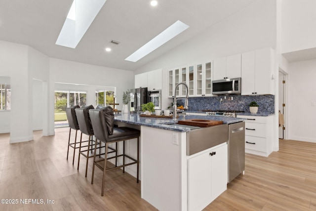 1465 Lambert Ave, Flagler Beach, FL 32136 - kitchen with stainless steel appliances, a skylight, a large island, high vaulted ceiling, and decorative backsplash