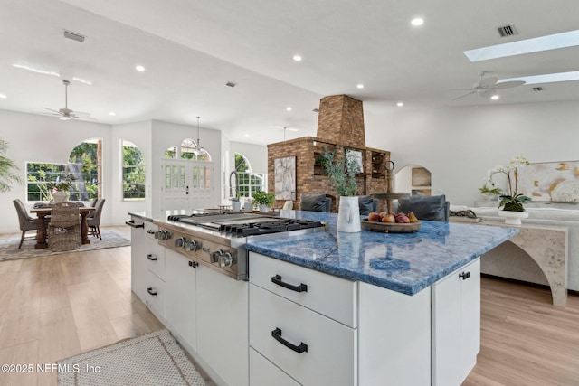 1465 Lambert Ave, Flagler Beach, FL 32136 - kitchen with ceiling fan, stainless steel gas stovetop, light wood-style flooring, open floor plan, and recessed lighting