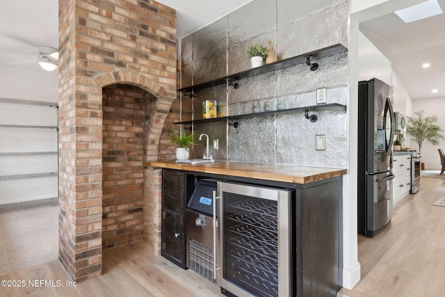 1465 Lambert Ave, Flagler Beach, FL 32136 - indoor bar with wine cooler, appliances with stainless steel finishes, light wood-type flooring, a ceiling fan, and recessed lighting