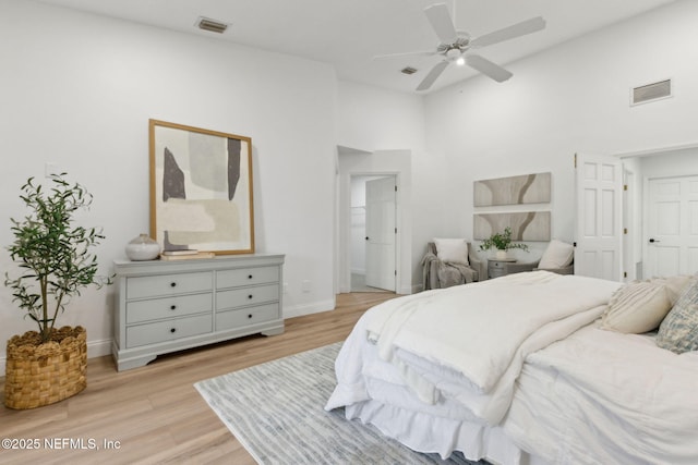 1465 Lambert Ave, Flagler Beach, FL 32136 - bedroom featuring light wood-style floors, a towering ceiling, and a ceiling fan