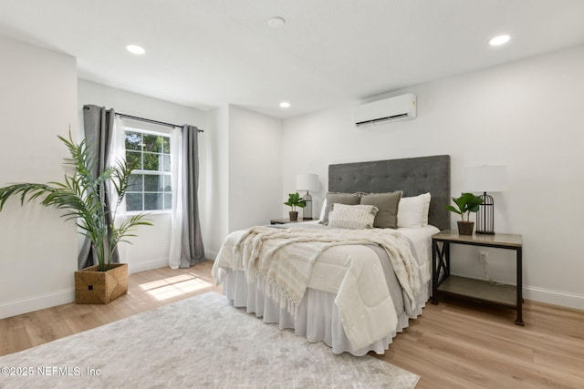 1465 Lambert Ave, Flagler Beach, FL 32136 - bedroom with a wall mounted AC, light wood-style flooring, and recessed lighting