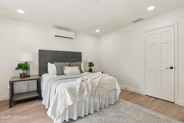 1465 Lambert Ave, Flagler Beach, FL 32136 - bedroom featuring an AC wall unit, wood finished floors, and recessed lighting