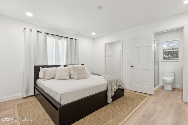 1465 Lambert Ave, Flagler Beach, FL 32136 - bedroom featuring light wood-type flooring, recessed lighting, ensuite bath, and a spacious closet
