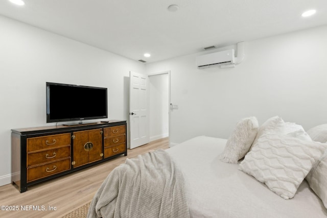 1465 Lambert Ave, Flagler Beach, FL 32136 - bedroom featuring a wall mounted air conditioner, light wood-type flooring, and recessed lighting