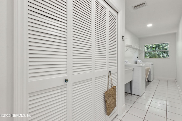 1465 Lambert Ave, Flagler Beach, FL 32136 - laundry area featuring separate washer and dryer, light tile patterned flooring, and recessed lighting