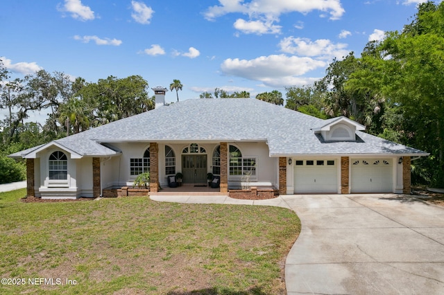 1465 Lambert Ave, Flagler Beach, FL 32136 - ranch-style house with driveway, a garage, a front lawn, covered porch, and brick siding