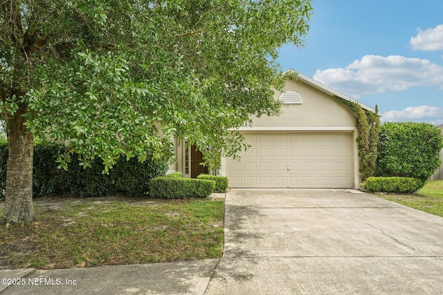3005 Sunset Ridge Dr, Middleburg, FL 32068 - obstructed view of property featuring driveway, a garage, and stucco siding