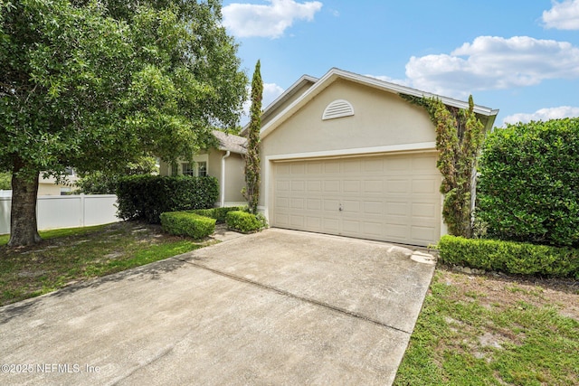 3005 Sunset Ridge Dr, Middleburg, FL 32068 - view of front of house featuring stucco siding, driveway, and an attached garage