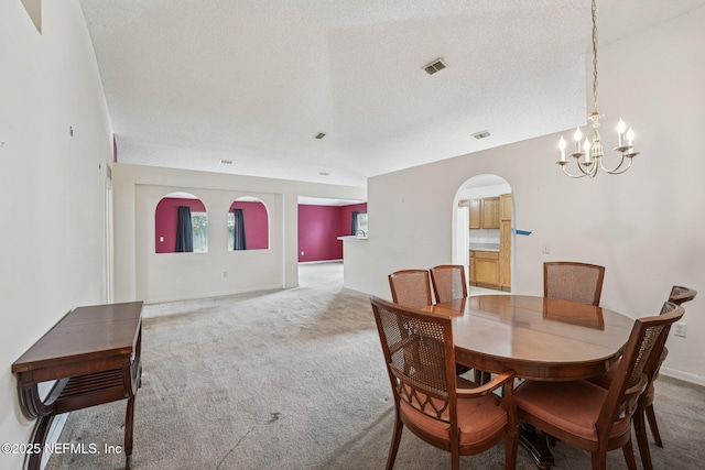 3005 Sunset Ridge Dr, Middleburg, FL 32068 - dining area with carpet, arched walkways, and a chandelier