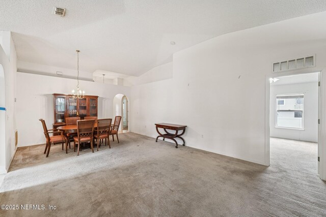 3005 Sunset Ridge Dr, Middleburg, FL 32068 - carpeted dining room featuring arched walkways, a chandelier, and vaulted ceiling