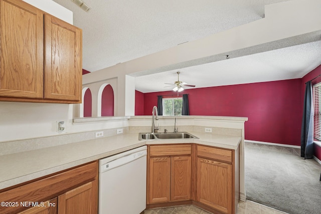 3005 Sunset Ridge Dr, Middleburg, FL 32068 - kitchen with dishwasher, a peninsula, a textured ceiling, light countertops, and ceiling fan