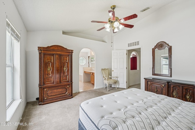 3005 Sunset Ridge Dr, Middleburg, FL 32068 - carpeted bedroom with arched walkways, vaulted ceiling, connected bathroom, and a ceiling fan