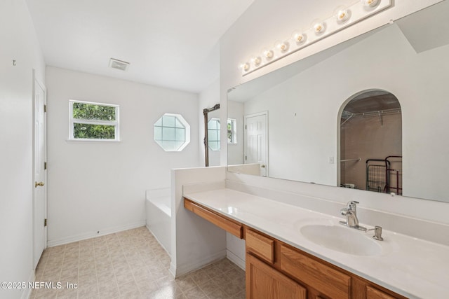 3005 Sunset Ridge Dr, Middleburg, FL 32068 - bathroom featuring vanity, a bath, and a closet