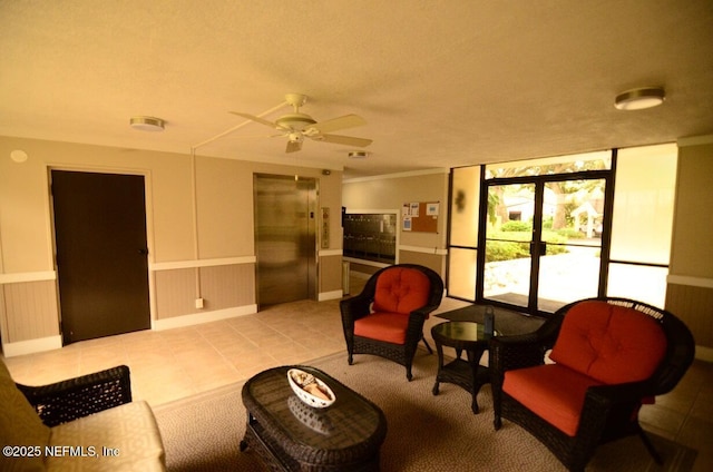1810 Sevilla Blvd Unit 202, Atlantic Beach, FL 32233 - living room with elevator, ceiling fan, light tile patterned floors, and wainscoting