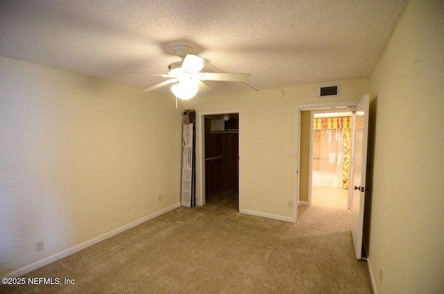 1810 Sevilla Blvd Unit 202, Atlantic Beach, FL 32233 - unfurnished bedroom with carpet flooring, a closet, a textured ceiling, and a ceiling fan