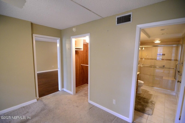 1810 Sevilla Blvd Unit 202, Atlantic Beach, FL 32233 - unfurnished bedroom with connected bathroom, a textured ceiling, and carpet floors