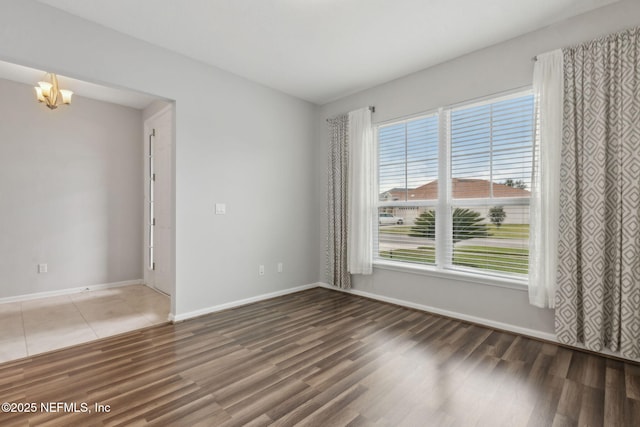 94032 Woodbrier Cir, Fernandina Beach, FL 32034 - spare room featuring wood finished floors and a chandelier