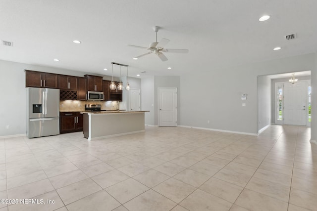 94032 Woodbrier Cir, Fernandina Beach, FL 32034 - kitchen featuring appliances with stainless steel finishes, backsplash, open floor plan, light tile patterned floors, and recessed lighting