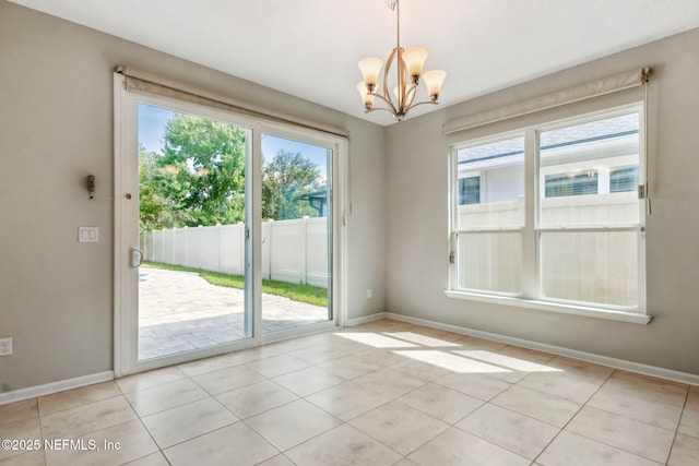 94032 Woodbrier Cir, Fernandina Beach, FL 32034 - empty room with a chandelier and light tile patterned floors