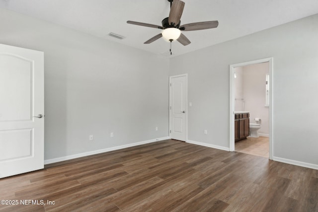 94032 Woodbrier Cir, Fernandina Beach, FL 32034 - unfurnished bedroom featuring wood finished floors, connected bathroom, and ceiling fan