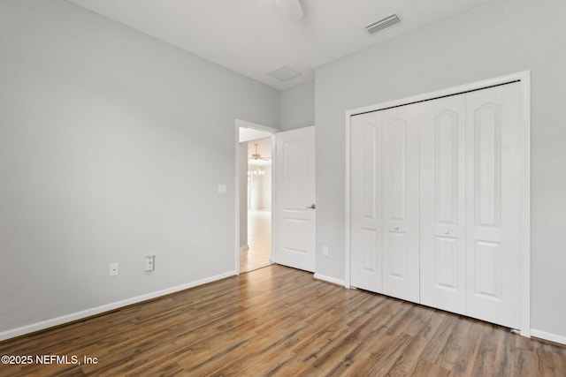 94032 Woodbrier Cir, Fernandina Beach, FL 32034 - unfurnished bedroom with wood finished floors, a closet, and a ceiling fan