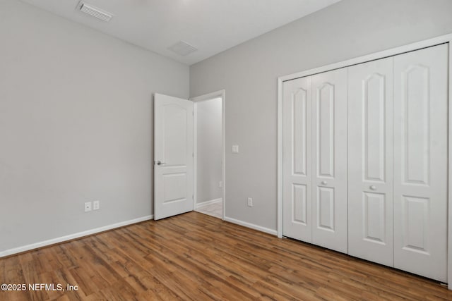 94032 Woodbrier Cir, Fernandina Beach, FL 32034 - unfurnished bedroom with wood finished floors and a closet