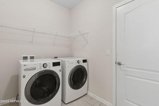 94032 Woodbrier Cir, Fernandina Beach, FL 32034 - laundry area featuring washing machine and clothes dryer and light tile patterned floors