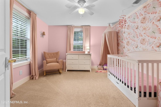 5263 Ellen Ct, Saint Augustine, FL 32086 - carpeted bedroom featuring a crib, multiple windows, and a ceiling fan