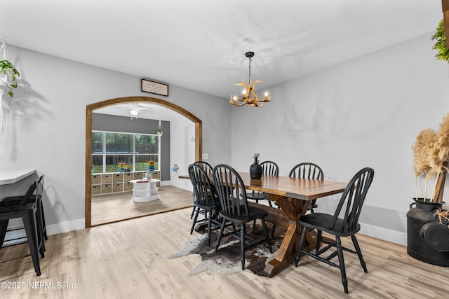 5263 Ellen Ct, Saint Augustine, FL 32086 - dining space featuring arched walkways, light wood finished floors, and a chandelier