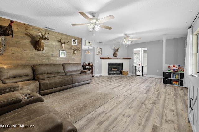 5263 Ellen Ct, Saint Augustine, FL 32086 - living room with ceiling fan, wooden walls, wood finished floors, and a fireplace