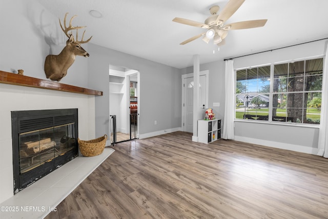 5263 Ellen Ct, Saint Augustine, FL 32086 - unfurnished living room with ceiling fan, a tile fireplace, and wood finished floors