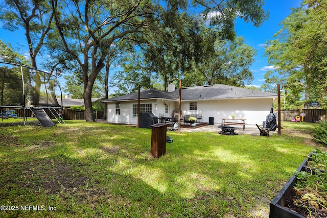 5263 Ellen Ct, Saint Augustine, FL 32086 - back of property featuring a trampoline, a fenced backyard, and a patio area