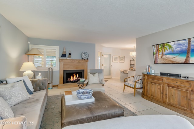 315 20th St, Atlantic Beach, FL 32233 - living area with light tile patterned floors, a lit fireplace, and a textured ceiling