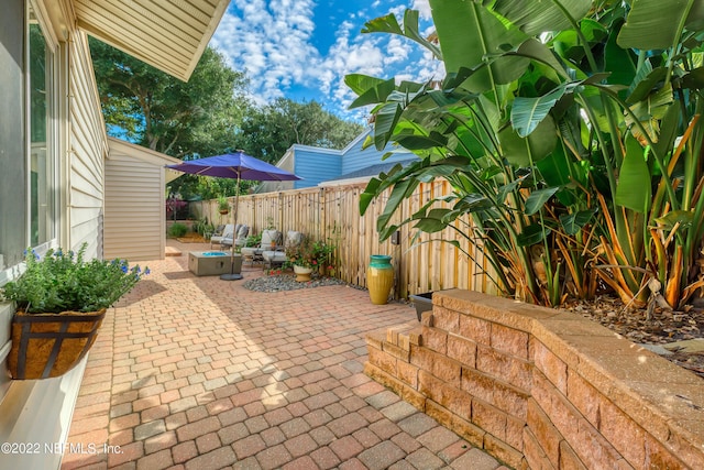 315 20th St, Atlantic Beach, FL 32233 - fenced backyard featuring a patio area and a fire pit