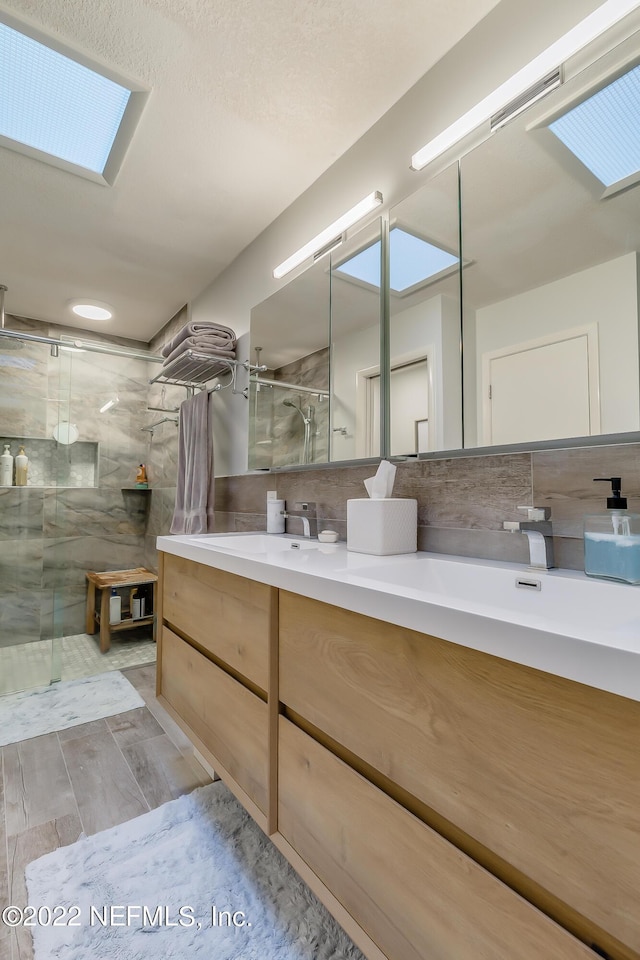 315 20th St, Atlantic Beach, FL 32233 - full bathroom featuring a marble finish shower, double vanity, and a skylight