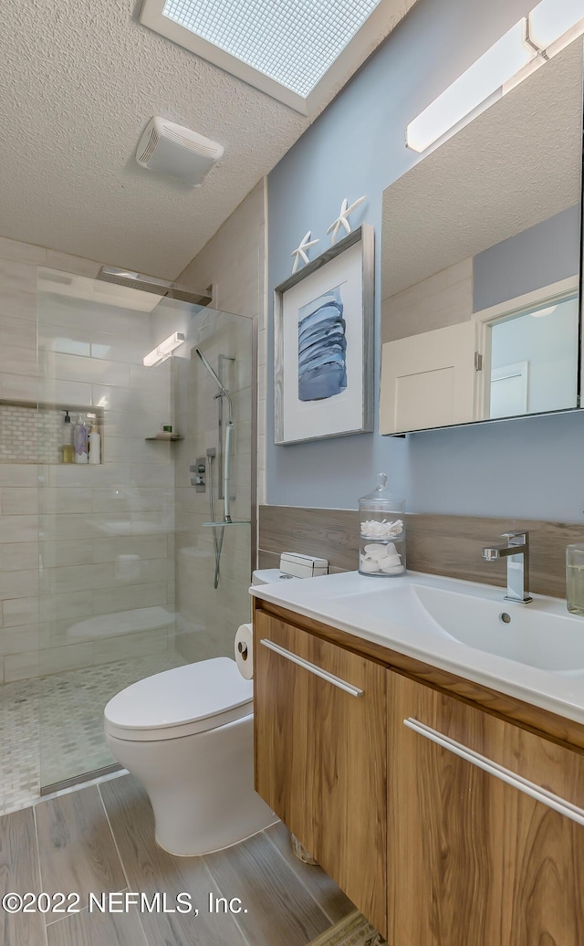 315 20th St, Atlantic Beach, FL 32233 - full bathroom with vanity, wood finished floors, walk in shower, and a textured ceiling