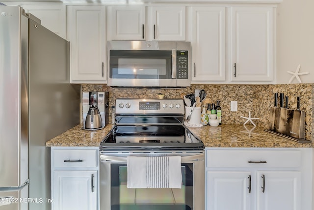 315 20th St, Atlantic Beach, FL 32233 - kitchen featuring stainless steel appliances, white cabinets, and backsplash