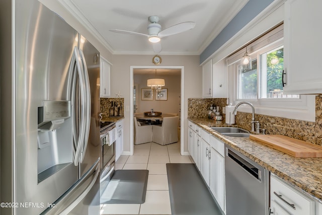 315 20th St, Atlantic Beach, FL 32233 - kitchen featuring appliances with stainless steel finishes, decorative backsplash, white cabinets, and ornamental molding