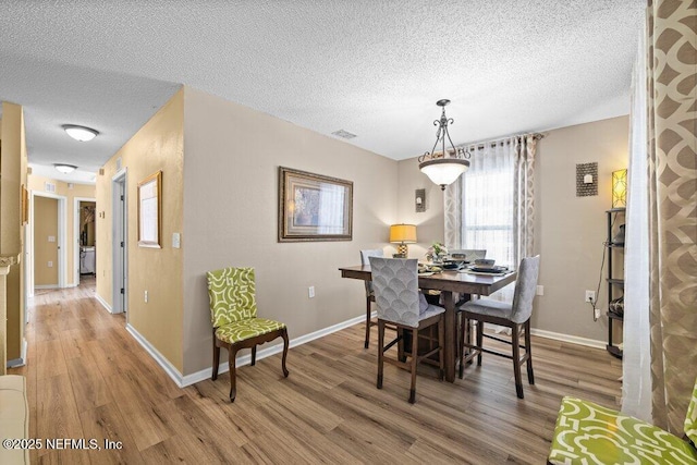 2548 Haywood Estates Ln, Jacksonville, FL 32233 - dining area featuring a textured ceiling and light wood finished floors